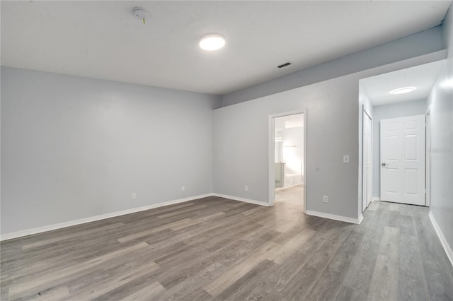 spare room with wood-type flooring