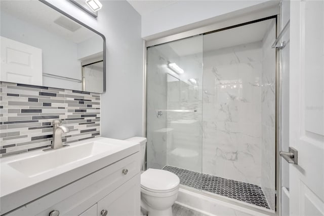 bathroom with tasteful backsplash, vanity, walk in shower, and toilet