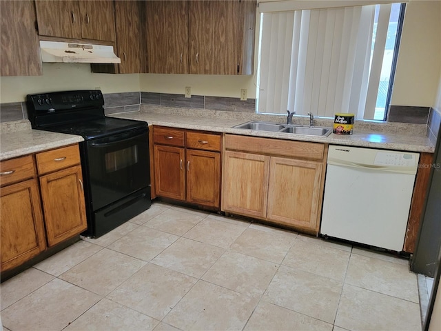 kitchen with white dishwasher, light tile patterned floors, sink, and black electric range