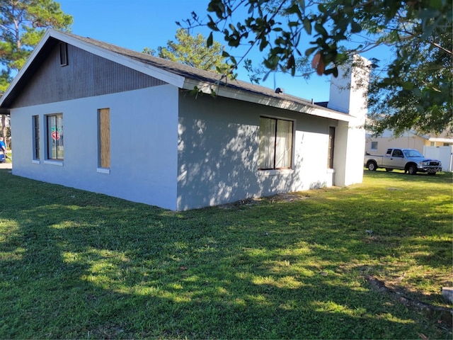 view of property exterior with a lawn