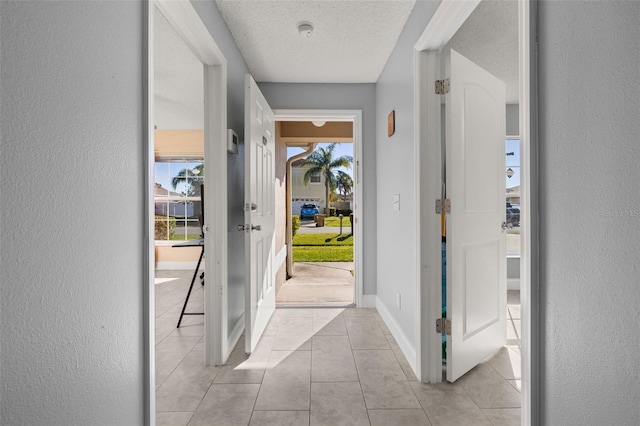 tiled foyer entrance featuring a textured ceiling