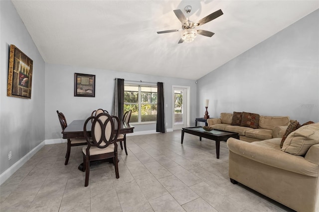 living room with ceiling fan, light tile patterned flooring, and vaulted ceiling