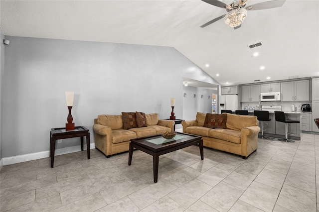 living room featuring ceiling fan, light tile patterned floors, and vaulted ceiling