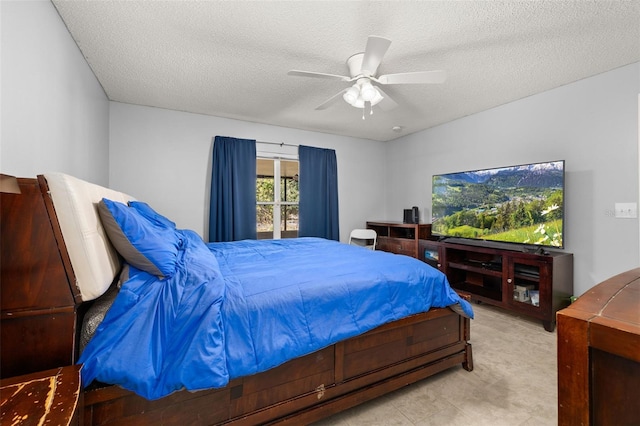 bedroom with ceiling fan and a textured ceiling