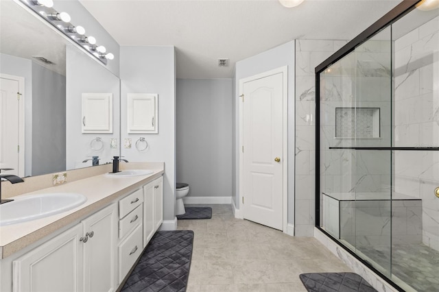 bathroom with tile patterned flooring, vanity, toilet, and an enclosed shower