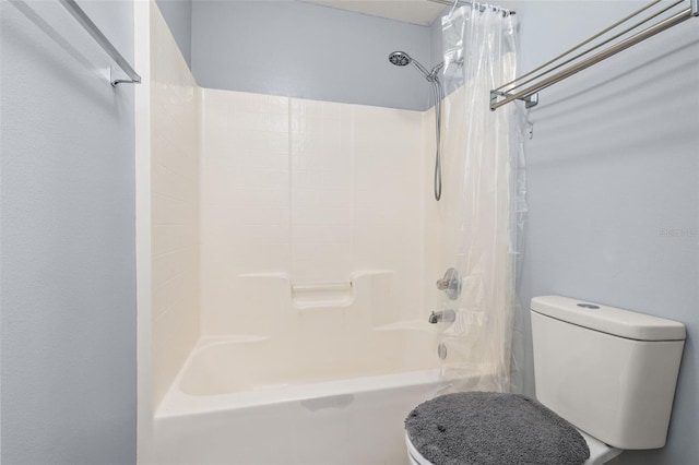 bathroom featuring shower / tub combo with curtain and toilet