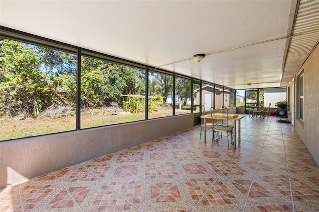 unfurnished sunroom featuring a wealth of natural light