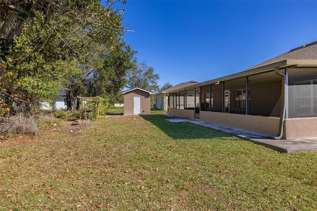 view of yard featuring a storage unit and a sunroom