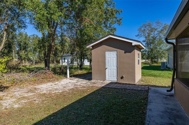 view of yard with cooling unit and an outdoor structure