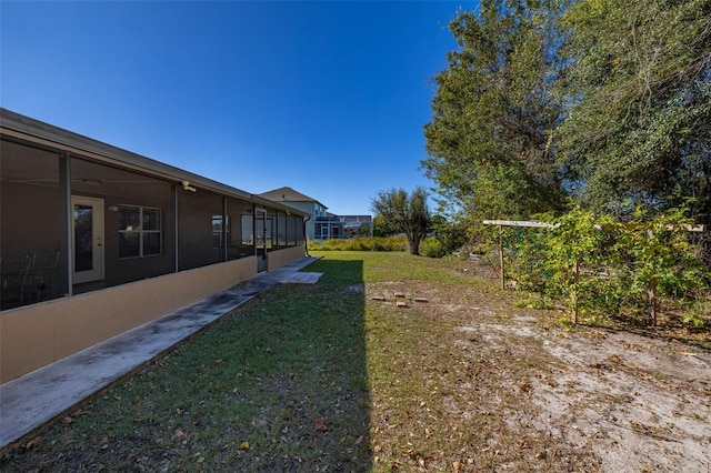 view of yard featuring a sunroom