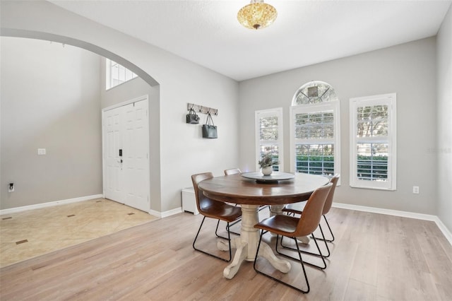 dining space featuring a textured ceiling and light hardwood / wood-style flooring