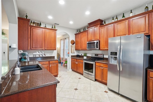 kitchen featuring stainless steel appliances, plenty of natural light, and sink