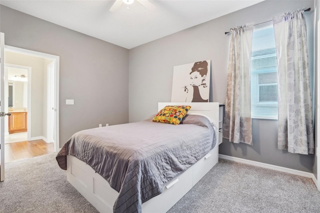 carpeted bedroom with connected bathroom and ceiling fan