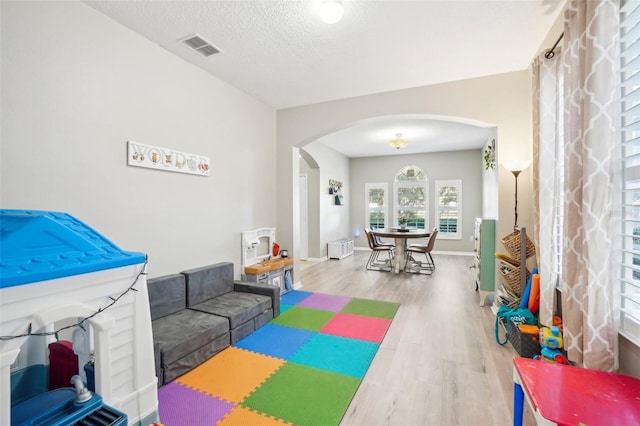 game room featuring a textured ceiling and hardwood / wood-style flooring