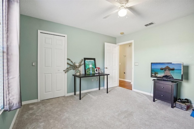 miscellaneous room featuring light carpet and ceiling fan