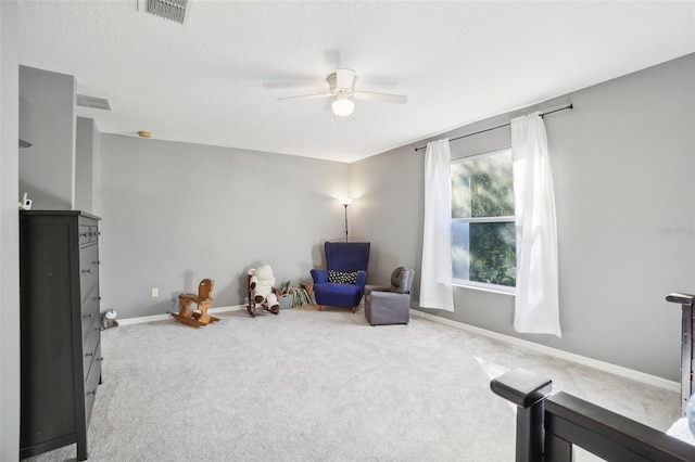 sitting room featuring carpet flooring and ceiling fan