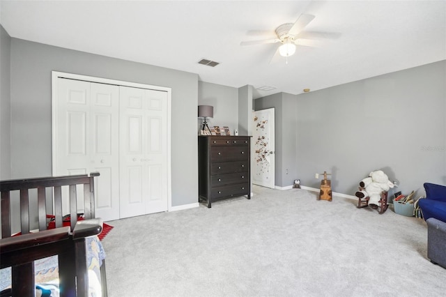 bedroom featuring light carpet, a closet, and ceiling fan