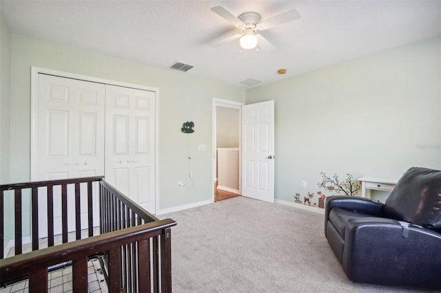 carpeted bedroom with ceiling fan and a closet