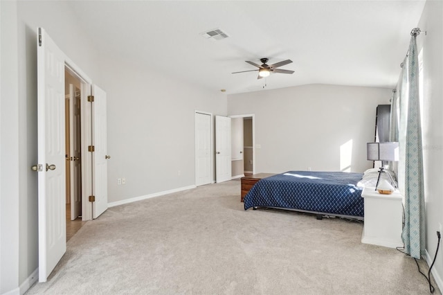 carpeted bedroom with ceiling fan and lofted ceiling