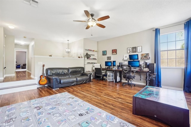 living room featuring ceiling fan and hardwood / wood-style floors