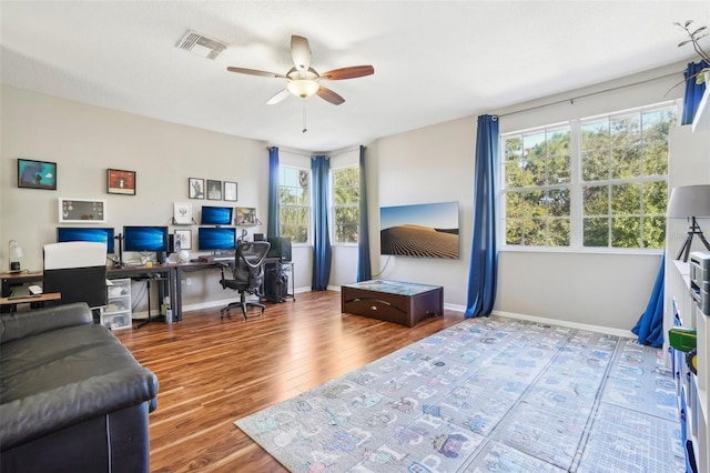 office featuring hardwood / wood-style flooring, ceiling fan, and a healthy amount of sunlight