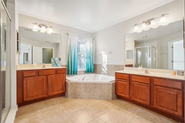 bathroom with tile patterned floors, vanity, and plus walk in shower