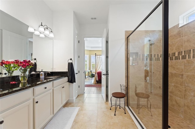 bathroom featuring tile patterned floors, plenty of natural light, vanity, and walk in shower