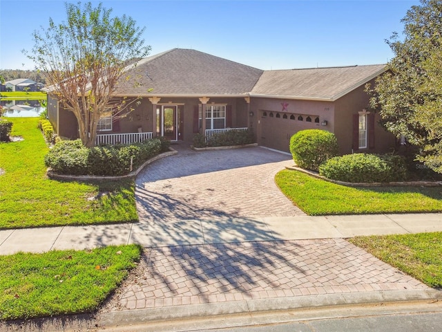 ranch-style home with covered porch and a garage