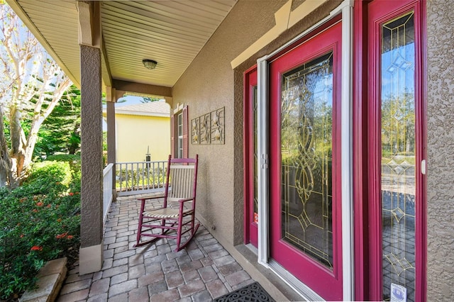 view of exterior entry featuring a porch