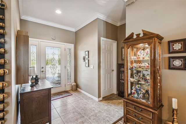 entryway featuring light tile patterned floors and crown molding