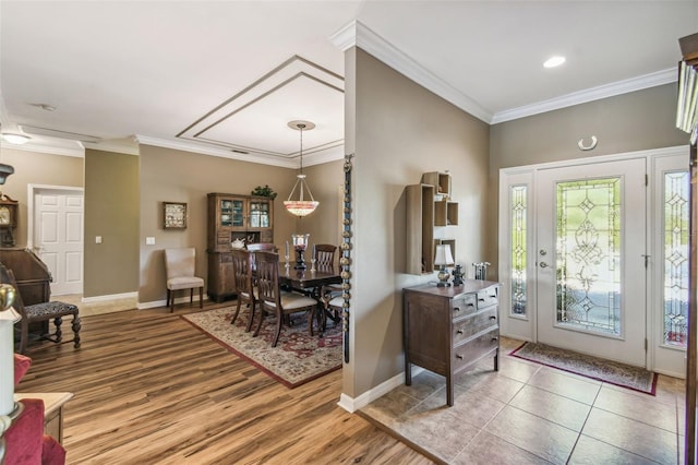 entryway featuring wood-type flooring and crown molding