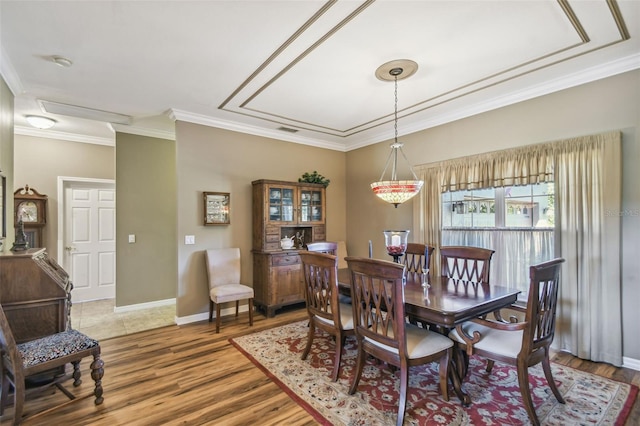 dining area featuring hardwood / wood-style floors and ornamental molding