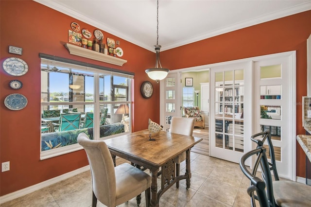 dining area featuring light tile patterned flooring, crown molding, and french doors