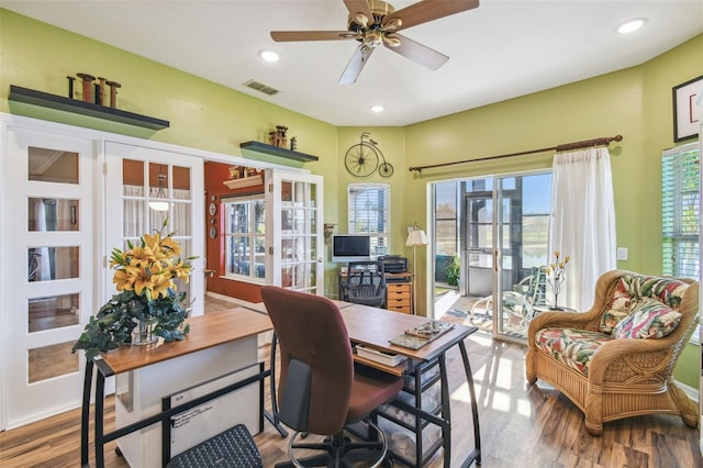 home office featuring ceiling fan, hardwood / wood-style floors, a healthy amount of sunlight, and french doors