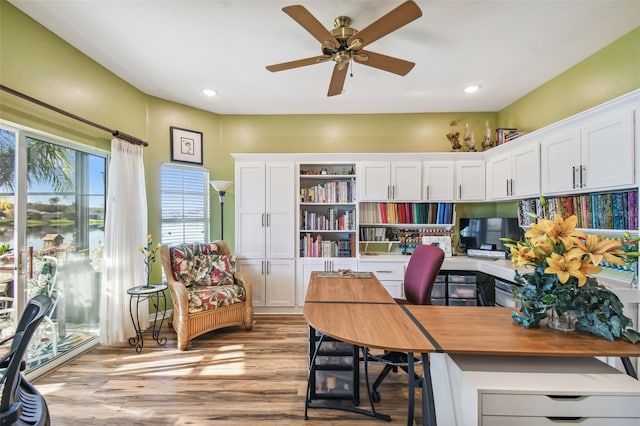 office area with light hardwood / wood-style flooring and ceiling fan