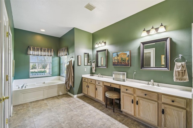 bathroom featuring a tub to relax in, tile patterned flooring, and vanity