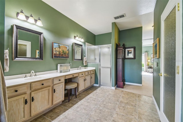 bathroom with tile patterned floors, vanity, and an enclosed shower