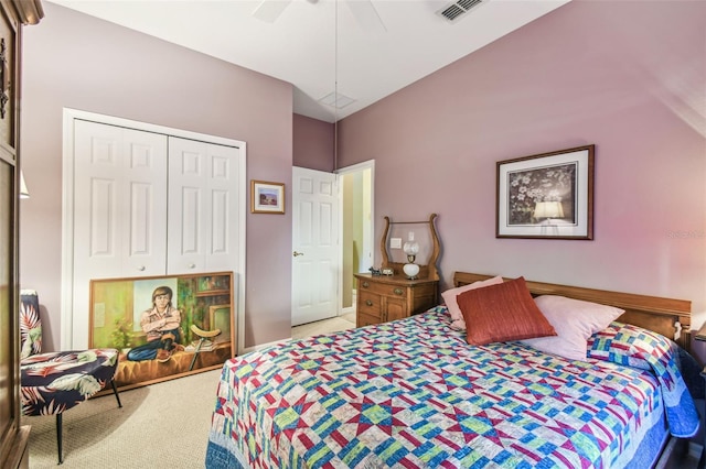 bedroom with ceiling fan, a closet, light colored carpet, and vaulted ceiling