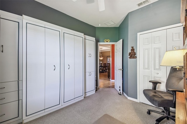 carpeted home office featuring ceiling fan