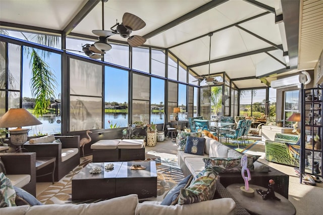 sunroom / solarium with ceiling fan, a water view, and lofted ceiling