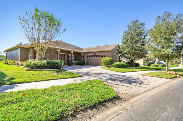 ranch-style home with a garage and a front lawn