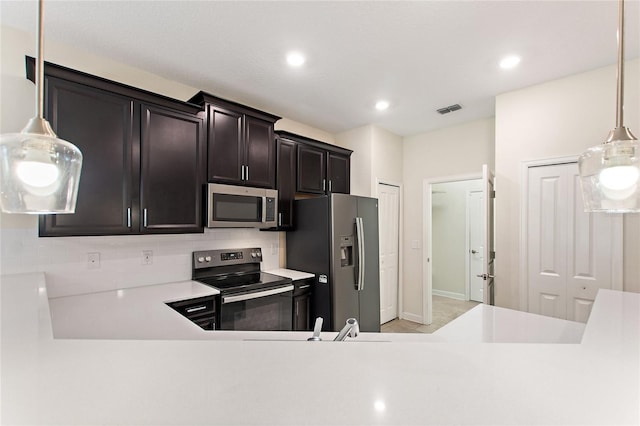 kitchen with decorative light fixtures and stainless steel appliances