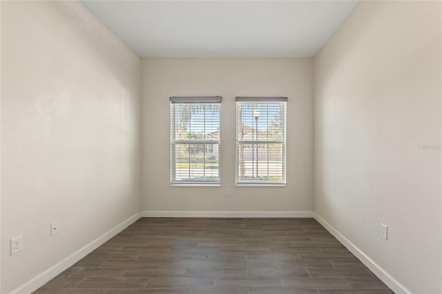 empty room with dark hardwood / wood-style flooring