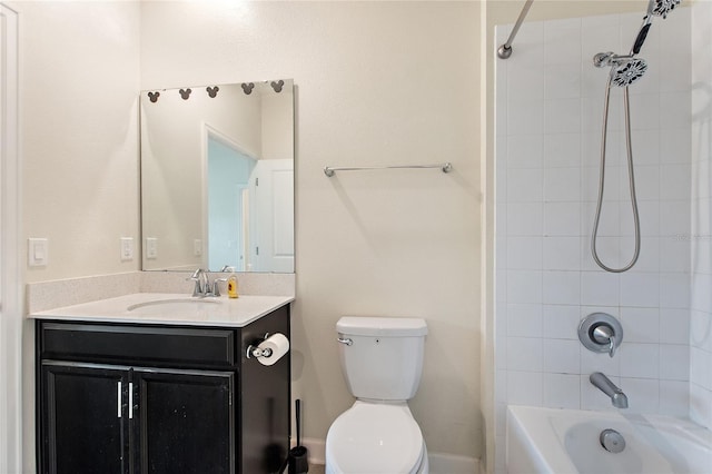 full bathroom with vanity, tiled shower / bath combo, and toilet