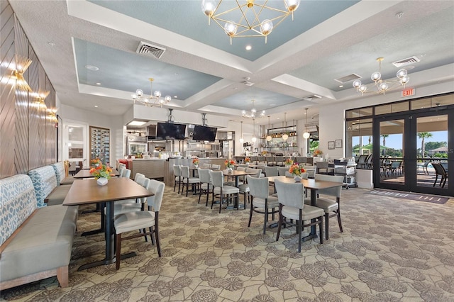 dining space featuring an inviting chandelier, french doors, coffered ceiling, a textured ceiling, and beamed ceiling