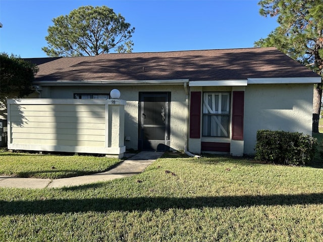 rear view of house with a yard