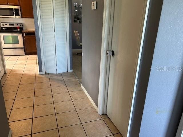 hallway featuring light tile patterned floors