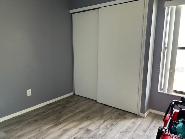 unfurnished bedroom featuring a closet and light hardwood / wood-style flooring