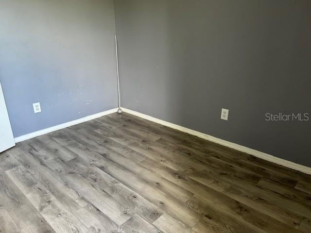 empty room with hardwood / wood-style floors