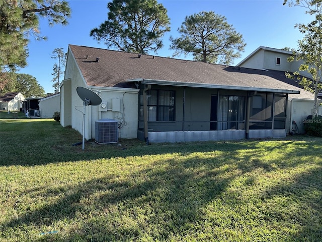 back of house with a yard, central AC unit, and a sunroom